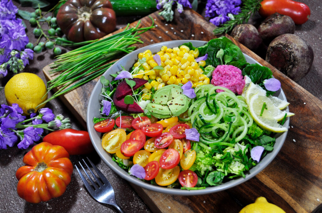 a bowl of veggies salad surrounded by vegetables